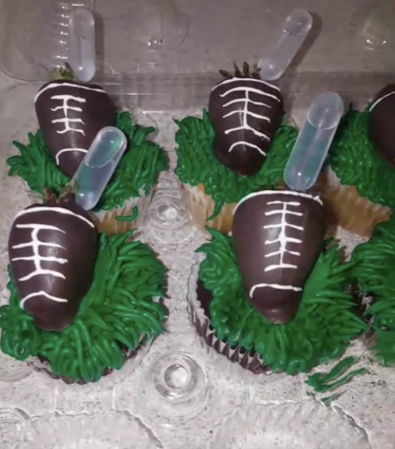 Football themed cupcakes with chocolate dipped strawberries